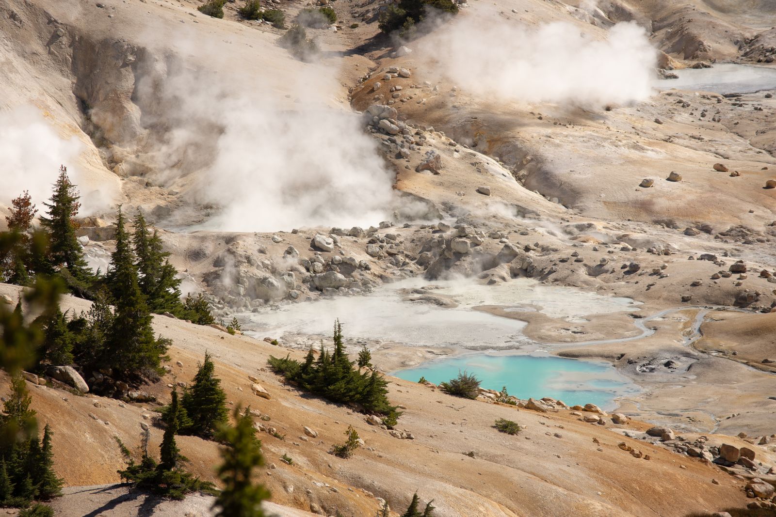 Steaming geothermal pools and pale mineral ground at Bumpass Hell